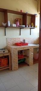 a kitchen with a counter with a sink in it at Akira Safaris Furnished Apartment in Migori