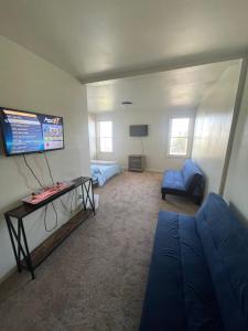 a living room with a couch and a tv at Kennedy House on Melrose Ave in Atlantic City