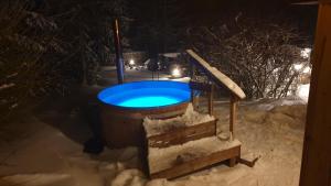 a swimming pool in the snow at night at hutzenAlm in Nassau