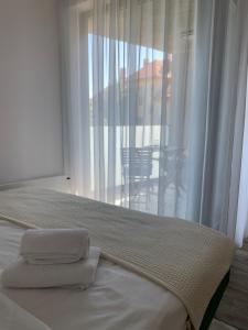 a bedroom with a bed with two towels on it at Ap-art-mán 08 in Mikulov