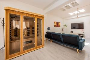 a living room with a couch and a tv at LOFT COSY - HYPERCENTRE - SAUNA - 200m2 - WIFI in Graulhet