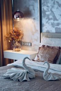 シュチェチンにあるHanza Tower -M&M Luxury Apartmentのベッドルームのベッドにタオル白鳥2枚 +12枚の写真