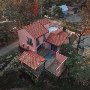 an overhead view of a pink house with red roofs at Pink Villa by Tubtao Sleepy Hill in Pong Talong
