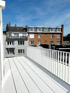 a balcony with a white fence and a building at Penthouse GuiZa in Namur