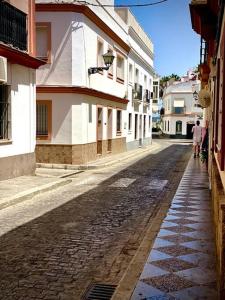 a cobblestone street in a city with buildings at MyChoice Dos Mares by Bossh! Apartments in Rota