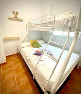 a bunk bed in a small room with a bunk bed at MyChoice Dos Mares by Bossh! Apartments in Rota