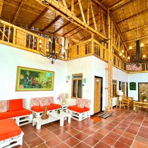 una sala de estar con muebles de color rojo y techo de madera. en Casa Gabriel Rivera en Rivera