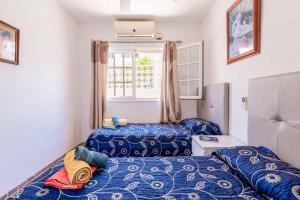 a small room with two beds and a window at Villa Lory in Callao Salvaje +28 photos