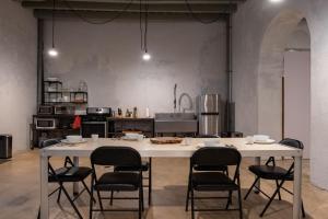 a kitchen with a large white table and chairs at Cozy Studio Gem - Old San Juan - Near Attractions in San Juan