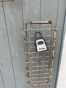 a toaster hanging on a metal rack on a door at Cozy Studio Gem - Old San Juan - Near Attractions in San Juan