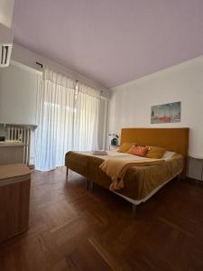 a bedroom with a large bed and a large window at The cozy apartment in heart of the Nice 1km to sea in Nice