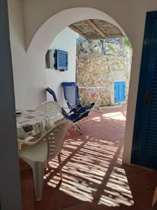 a room with a table and a chair in a building at Appartamenti Villa Lina in Nisporto