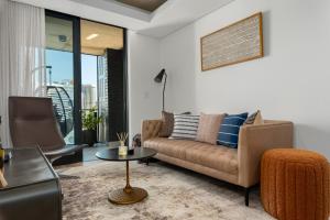 a living room with a couch and a table at Station House Apartments in Cape Town