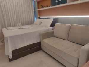 a room with a couch and a bed and a chair at Luar Porto de Galinhas in Porto De Galinhas