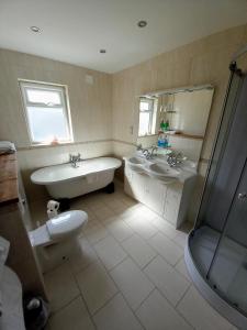 a bathroom with a tub and a sink and a bath tub at Cellar Cove in Perranporth