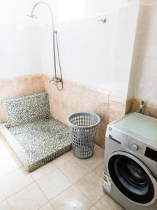 a washing machine and a bench in a bathroom at Residential House 3 Bedroom, 1 Bathroom Entire unit in Beau Bassin in Beau Bassin