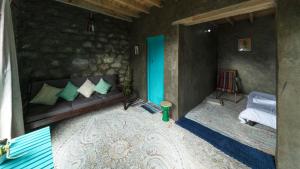 a living room with a couch and a bed at Hillhouse Hunza in Hunza