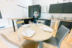 una cocina con mesa y sillas con copas de vino en Relax & Design in Saint-Egrève #DQ en Saint-Égrève