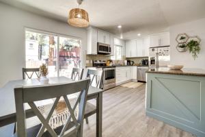 a kitchen with white cabinets and a table with chairs at Pet-Friendly South Lake Tahoe Vacation Rental! in South Lake Tahoe