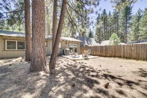 a backyard with a house and a fence and trees at Pet-Friendly South Lake Tahoe Vacation Rental! in South Lake Tahoe