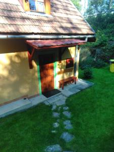 a small house with a bench in front of it at Chalupa Mlyn Dolný Kubín in Dolný Kubín