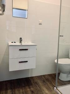 a bathroom with a sink and a toilet at Motel Orzeł in Szczecinek