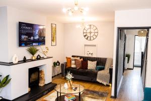 a living room with a couch and a fireplace at Luxurious 3-Bed House in Dudley - DY1 in Dudley