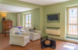 a living room with two chairs and a flat screen tv at EasyTopStay - Piazza Venezia Charming & Bright Apt in Rome