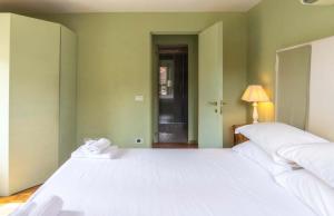 a bedroom with a large white bed and a lamp at EasyTopStay - Piazza Venezia Charming & Bright Apt in Rome