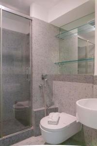 a bathroom with a shower and a toilet and a sink at EasyTopStay - Piazza Venezia Charming & Bright Apt in Rome