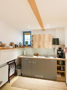 a kitchen with a sink and a counter at Ferienapartment Opitz - Zugspitzregion in Ohlstadt