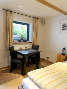 - une chambre avec un bureau, un lit et une fenêtre dans l'établissement Ferienapartment Opitz - Zugspitzregion, à Ohlstadt