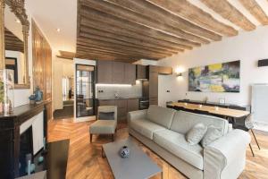 a living room with a couch and a table at Contrevents in Paris