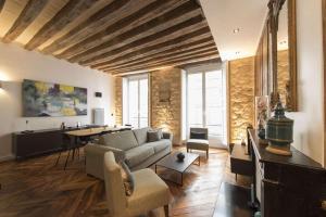 a living room with a couch and a table at Contrevents in Paris