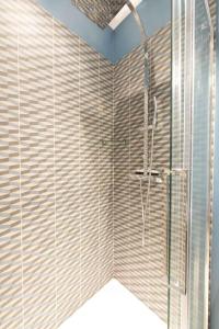 a bathroom with a shower with a glass door at Contrevents in Paris
