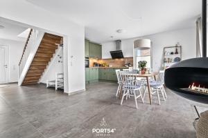 a kitchen and dining room with a table and a fireplace at Ferienhaus Villa Dein Zuhause am Meer in Büsum