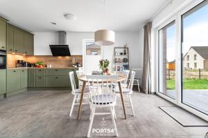 a kitchen and dining room with a table and chairs at Ferienhaus Villa Dein Zuhause am Meer in Büsum +30 photos
