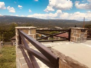 a view from the balcony of a house with a wooden railing at Villa Vakalis in Ioannina