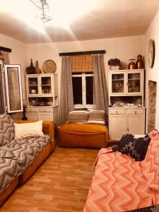 a living room with a couch and a bed and a window at Villa Vakalis in Ioannina