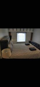 a bedroom with a large bed and a window at The Lifeboat & Seaview Terrace in Skerries