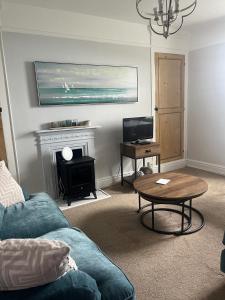 a living room with a couch and a table at Seascape in Lynton