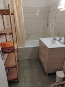 ein Badezimmer mit einer Badewanne, einem Waschbecken und einer Leiter in der Unterkunft Bienvenue en sud gironde in Villandraut