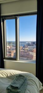 a bedroom with a bed and a window with a view at Sea & City view Home near Nature in Helsinki