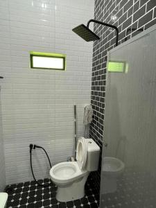 a bathroom with a white toilet and a sink at Rumah Armand 3 Bedroom with Swimming Pool Pengkalan Balak Tg Bidara Masjid Tanah Melaka in Masjid Tanah