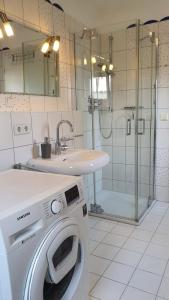 a bathroom with a washing machine and a sink at Ferienhaus Marleen in Pritzier