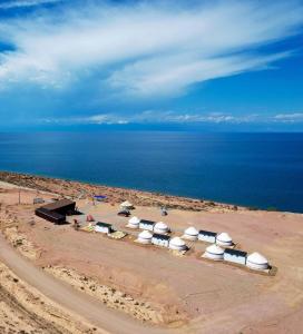 a group of tents with the ocean in the background at Royal Gate at Skazka Canyon in Tong