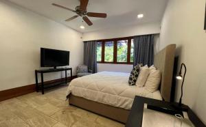 a bedroom with a bed and a flat screen tv at Sunny Vacation Villa NO 87 in San Rafael del Yuma