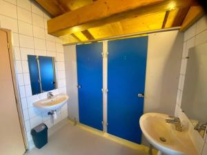 a bathroom with a blue door and a sink at Gîte La Loriaz in Vallorcine