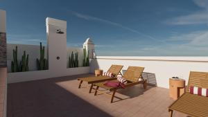 a balcony with two chairs and a table and avisor at BYPILLOW Casa Gades in Cádiz