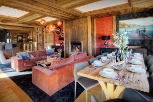 a living room with a table and a couch at Chalet Kalyssia - OVO Network in Saint-Jorioz
